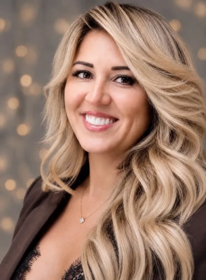 Maryam Kasimova in a brown blazer, smiling