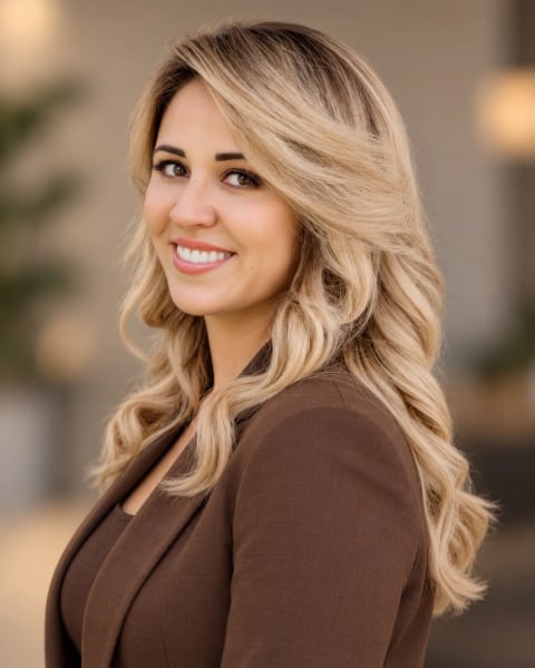 Maryam Kasimova, independent insurance agent, smiling in a brown blazer