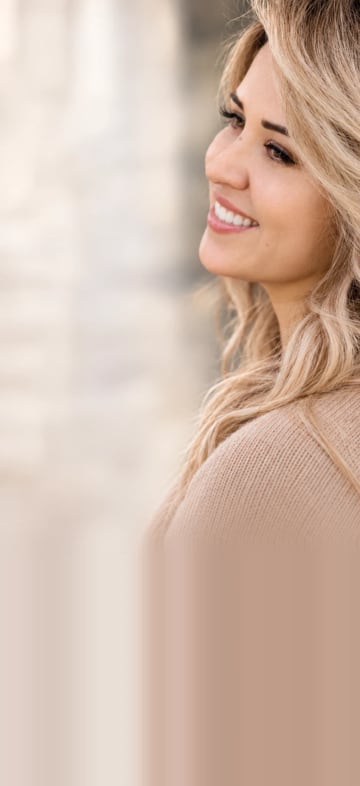 Close-up of a smiling woman in profile